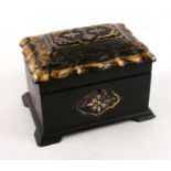 A 19th papier mache tea caddy with tortoiseshell inlay. Width 21cms (8.25ins) by 14cms (5.5ins)