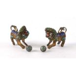 A pair of Chinese gilt metal and enamel temple lions, 8cms long (2).