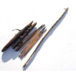A tribal fishing bow, 123cms long; together with two hide bound wooden quivers containing metal