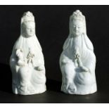 A pair of Chinese blanc de chine joss stick holders depicting Guanyin, 19cms high (2).