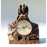 An early 20th century carved oak mantle clock, the case surmounted with a figure of Father Time, the