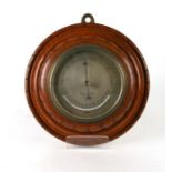 An Edwardian aneroid barometer, the silvered dial signed 'Dollond, London', in an oak case, 30cms