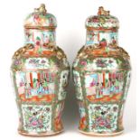 A large pair of Chinese Canton vases and covers of baluster form, decorated with panels of