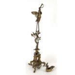 A gilt metal Roman oil lamp stand in the form of a stork with a snake in its beak, on a naturalistic
