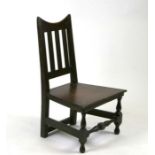 An 18th century style oak child's char with solid seat on turned supports.