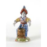 A faience style pottery figural spill vase, 18cms high.