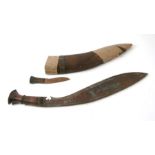 A large kukri in a carved wooden scabbard, 55cms long.