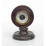 A Cornish serpentine desktop barometer, 14cms high.