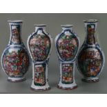 An 18th century Chinese part garniture of four vases, each decorated with a panel of Mandarin