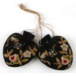 A pair of Chinese black silk purses embroidered with bats and fruit (2).