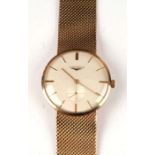 A 9ct gold Longines gentleman's wristwatch with bracelet strap, the 3.2cms champagne dial with baton