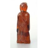 A Peking amber glass figure depicting a sage, 10cms high.