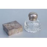 An Edwardian silver mounted cut glass desk inkwell engraved with two crests, 9cms high; together