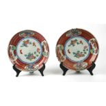 A pair of Chinese plates decorated with flowers and butterflies, 23cms diameter.