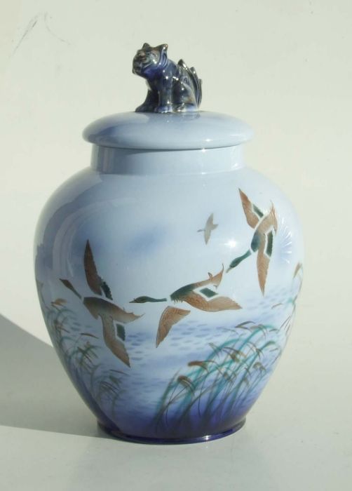 A Sylvac Falcon ware jar and cover decorated with a flock of ducks, the base signed and impressed,