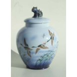 A Sylvac Falcon ware jar and cover decorated with a flock of ducks, the base signed and impressed,