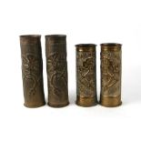 A pair of WWI trench art souvenir shell cases, 23cms high; together with another similar pair, 27cms