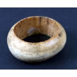 An African tribal carved bangle of large proportions, 13cms diameter.