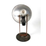 A vintage industrial adjustable lamp with aluminium shade, on a cast iron base stamped 'Commercial',