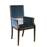 An Arts & Crafts mahogany elbow chair with upholstered seat and back, on square tapering legs.