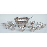 A George III style silver plated punch bowl, 30cms diameter and twelve matching cups and ladle;