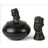 A Zulu terracotta box and cover, the cover with Zulu chief finial, 11cms diameter; together with a