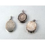Three Victorian white metal lockets (test as silver), largest 5cm (3)