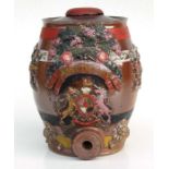 A 19th century glazed stoneware raspberry cordial barrel decorated with flowers and an armorial