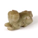 A Chinese russet jade carving in the form of a recumbent lion, 6cms long.