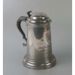 A 19th century lidded pewter trophy tankard 'CCC Challenge Fours 1883', 21cms high.