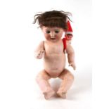 A German bisque headed doll with sleeping blue eyes, open mouth exposing two teeth, impressed '