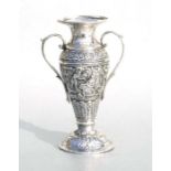 A Persian white metal two-handled vase highly decorated with figural scenes, 15cms high.