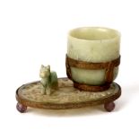 A Chinese gilt metal mounted jade or hardstone cup or brush washer on a pierced stand with three