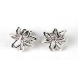 A pair of 18ct white gold diamond set flower earrings, 3.2g.
