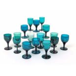 Sixteen various green wine glasses late 18th/19th century, with rounded funnel bowls and raised on