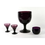 A large Studio glass amethyst rummer, 22cms diameter; together with two other rummers, 10cms