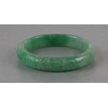 A Chinese Republic carved apple green jade bangle, 7cms diameter.Condition Reportgood overall