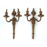 A pair of Adam style gilt brass wall brackets with urn finials, 43cms high (2).