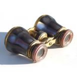 A pair of 19th century Palais Royale gilt metal and mother of pearl opera glasses, 10cms wide.