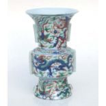 A Chinese famille rose vase decorated with dragons and phoenix, 25.5cms high.Condition Report