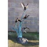 An Escar Bronzes large bronzed and patinated water feature depicting three ducks in flight amongst