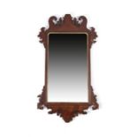 A George II fret frame wall mirror, the later rectangular plate with arched top corners in a