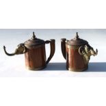 A pair of 19th century Prussian brass mounted oak welcome jugs with elephant and ram masks,