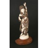 A large late 19th / early 20th century Indian ivory figure highly decorated with applied engraved