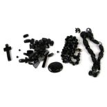 A quantity of Victorian Whitby Jet jewellery to include a cross, plaque, necklace and unstrung