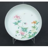 A Chinese famille rose shallow bowl decorated with flowers and butterflies, six character blue