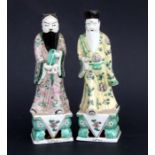 A pair of Chinese famille vert figures of dignitaries, the largest 33cms high (2).