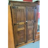OAK WARDROBE WITH CARVED PANELS, IN THE STYLE OF OLD CHARM
