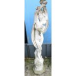 ARCHITECTURAL SALVAGE - RECONSTITUTED STONE STAUE OF AN ELEGANT FEMALE ON A CIRCULAR BASE