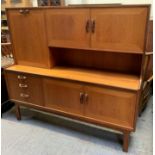 A G-Plan Fresco sideboard with twin cupboard doors and pull down door with internal shelf above a